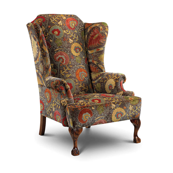 Cavendish Wing Chair with multicoloured floral upholstery and carved wooden legs.