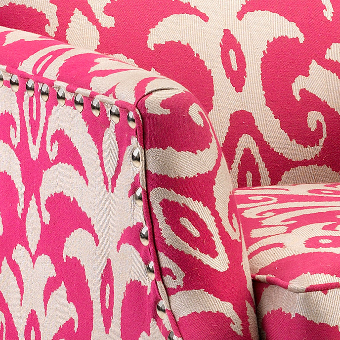 Close-up of a pink and white patterned fabric with metallic accents.