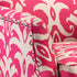 Close-up of a pink and white patterned fabric with metallic accents.