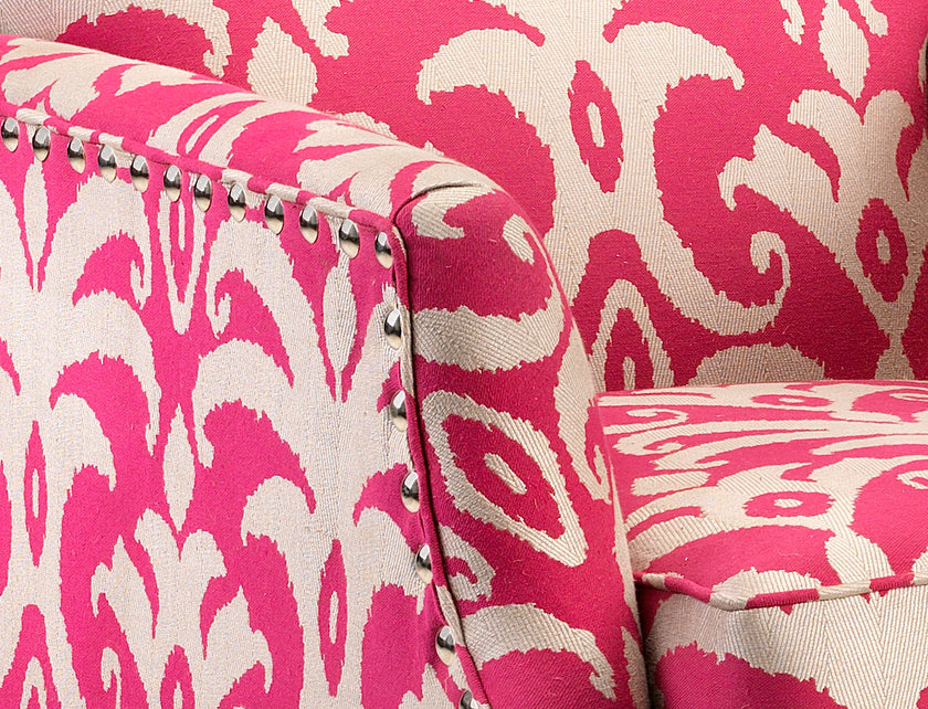 Close-up of a pink and white patterned fabric with metallic accents.