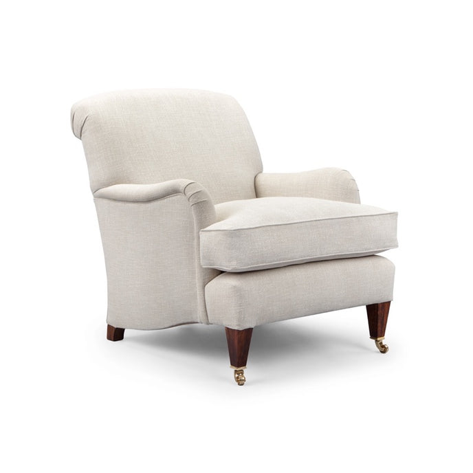 Ladies Howard armchair upholstered in light beige linen fabric with rolled arms and tapered wooden legs with brass castors