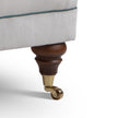 Close-up of a Library chair's leg with a wooden and brass finish 