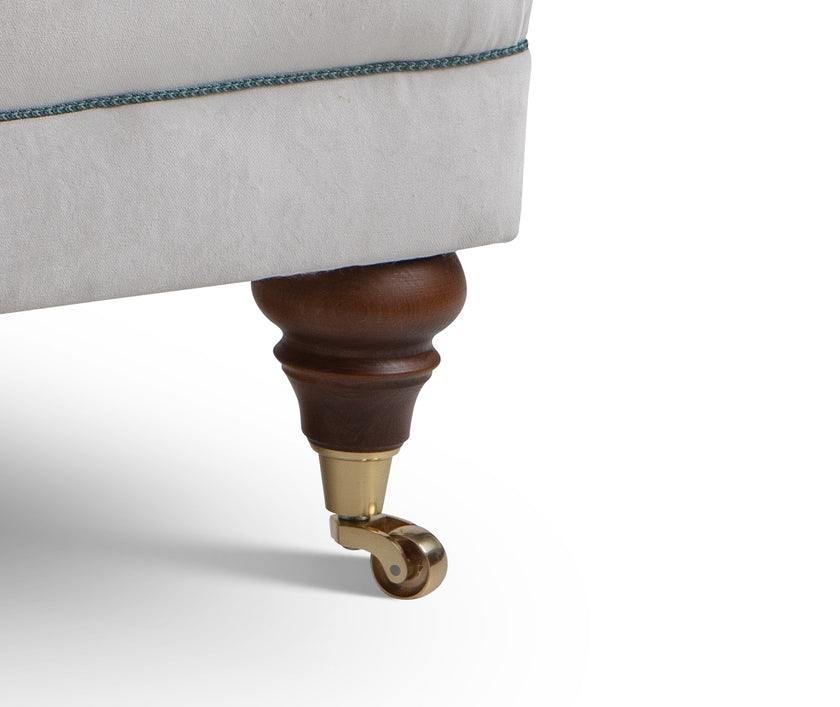 Close-up of a Library chair's leg with a wooden and brass finish 