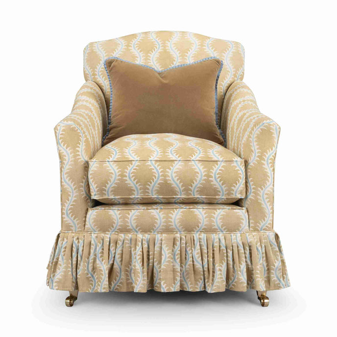 Macey armchair in gold and blue patterned fabric with a matching ruffled skirt
