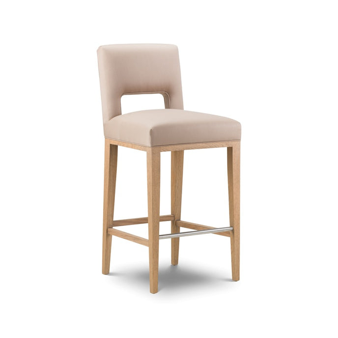 Spencer Bar Stool upholstered in beige fabric with light wooden legs and a metal footrest