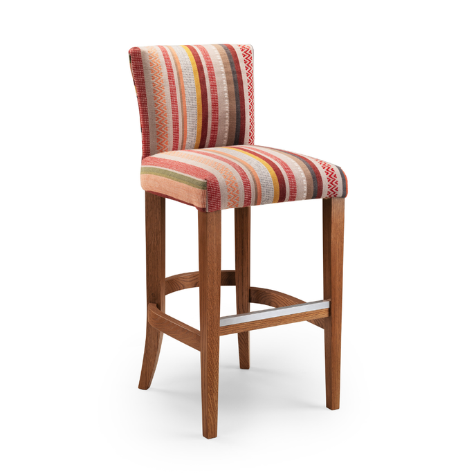 Neptune Bar Stool upholstered in multicoloured striped fabric with wooden legs and a metal footrest