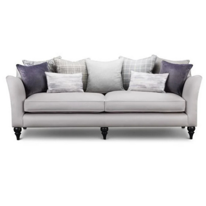 Soho Sofa upholstered in light grey fabric with accent cushions and turned dark wooden legs