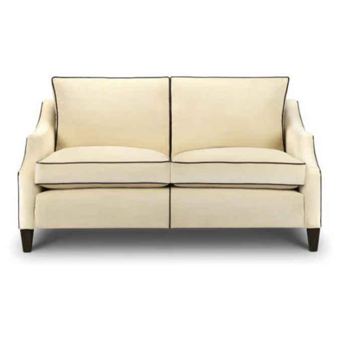 Townhouse Sofa upholstered in cream fabric with contrast piping and dark wooden legs