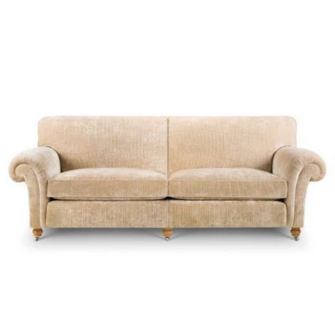 Blenheim Sofa upholstered in beige velvet with rolled arms and brass castors