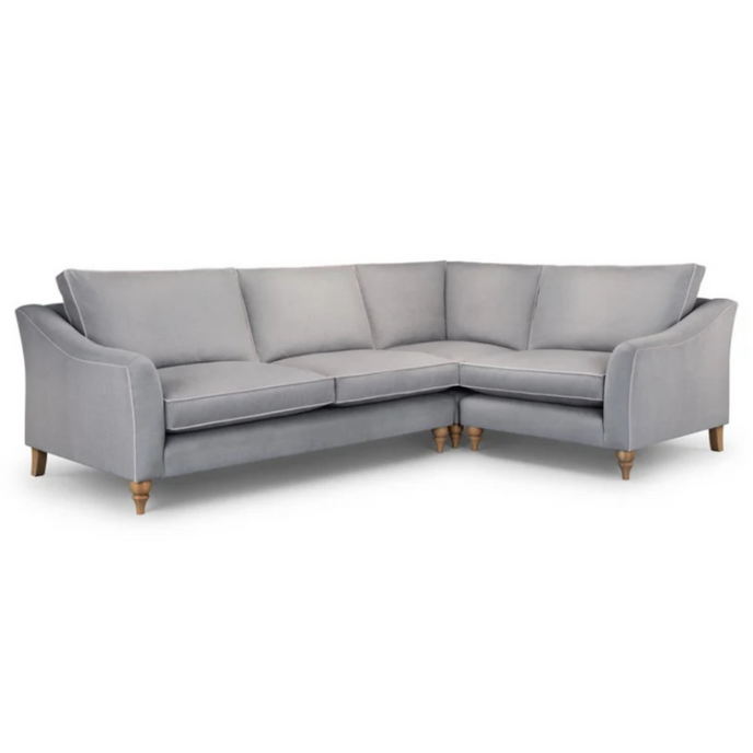 Havana Corner Sofa upholstered in light grey fabric with contrast piping and turned wooden legs