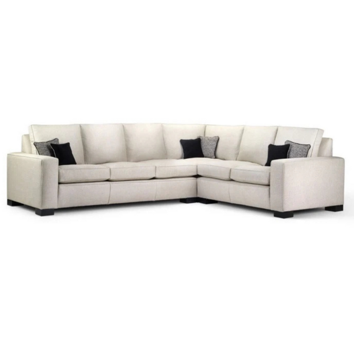 Wentworth Corner Sofa upholstered in cream fabric with back cushions and dark wooden block feet
