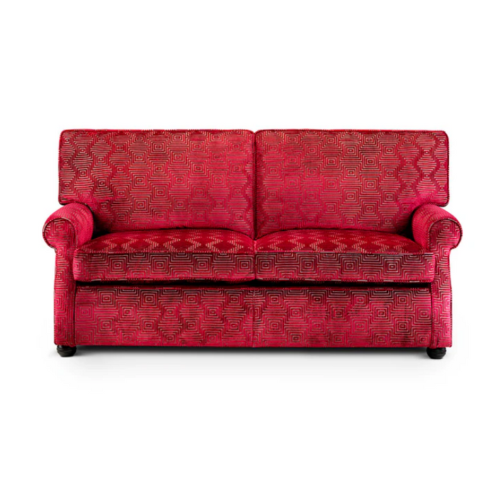 Classic Skirted Sofabed upholstered in red geometric patterned fabric with rolled arms and a skirted base