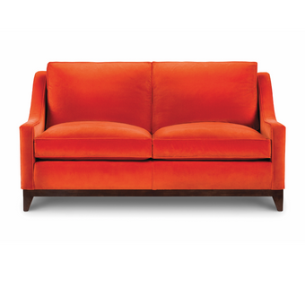 Ritz Sofa upholstered in bright orange velvet with loose back cushions and dark wooden legs