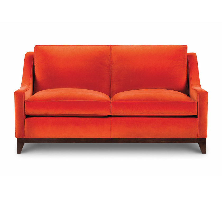 Ritz Sofa upholstered in bright orange velvet with loose back cushions and dark wooden legs